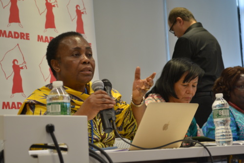 Julienne Lusenge speaking into a mic at a panel