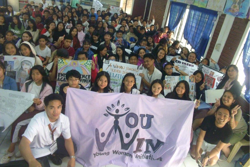a very large group of young people gathered with posters in the Philippines