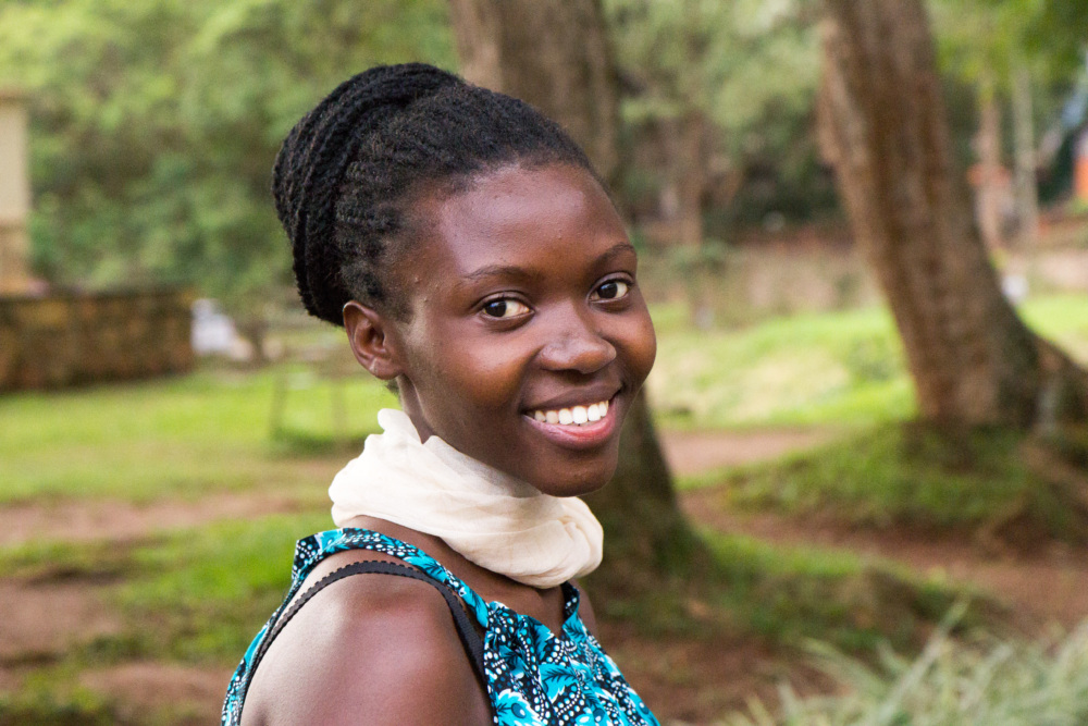 a woman smiles at he camera seen from the shoulders up