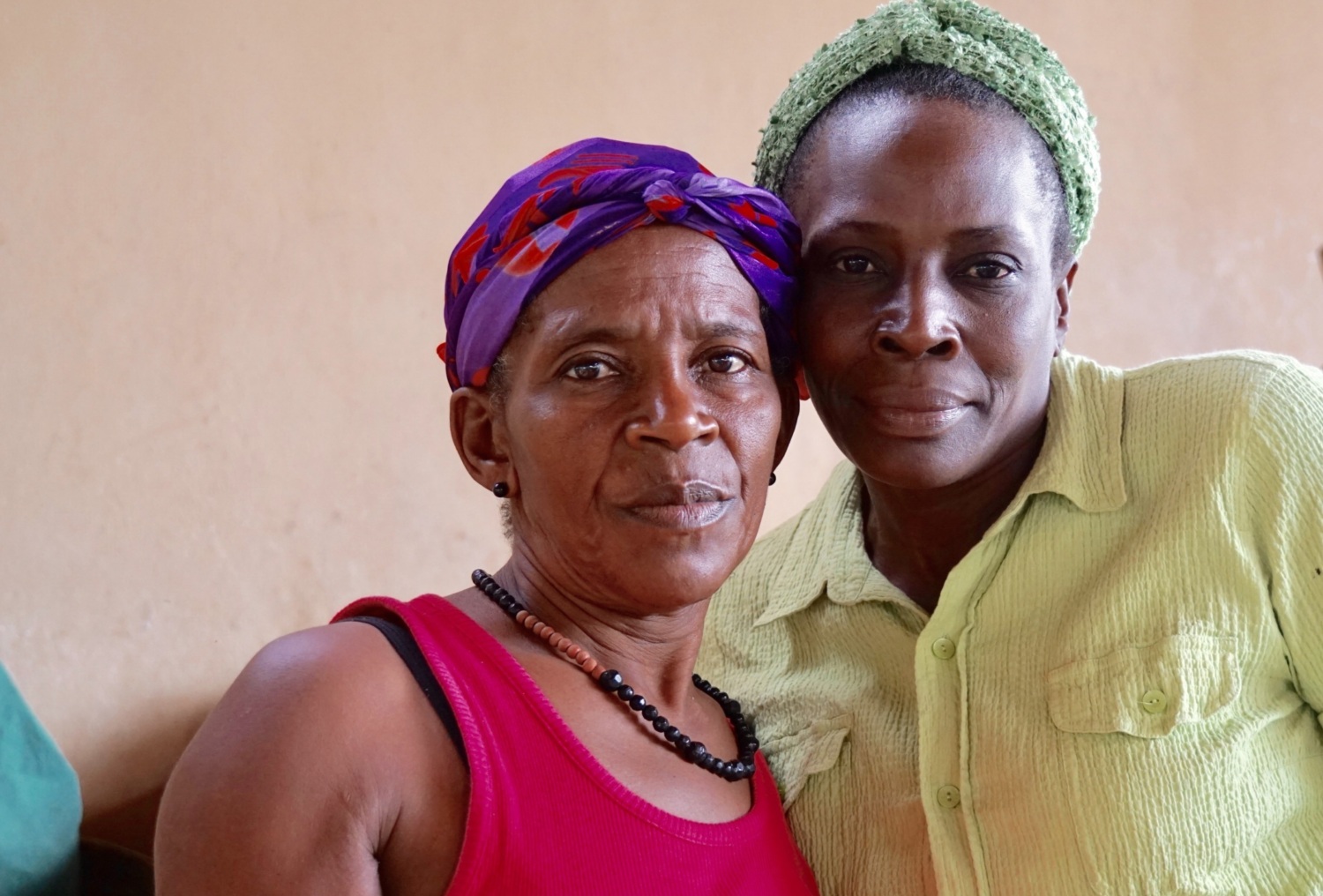 two Haitian women in market look at camera