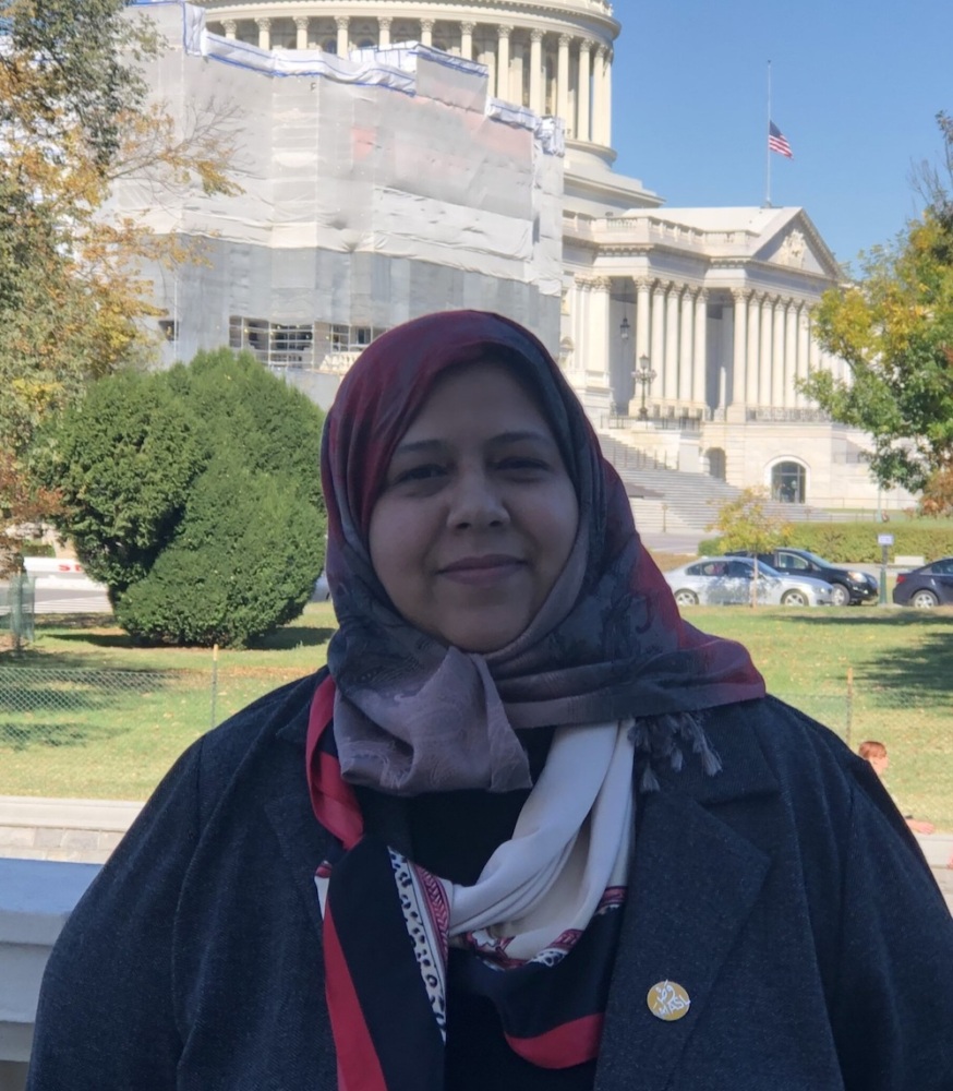 Muna stands in front of us capitol building