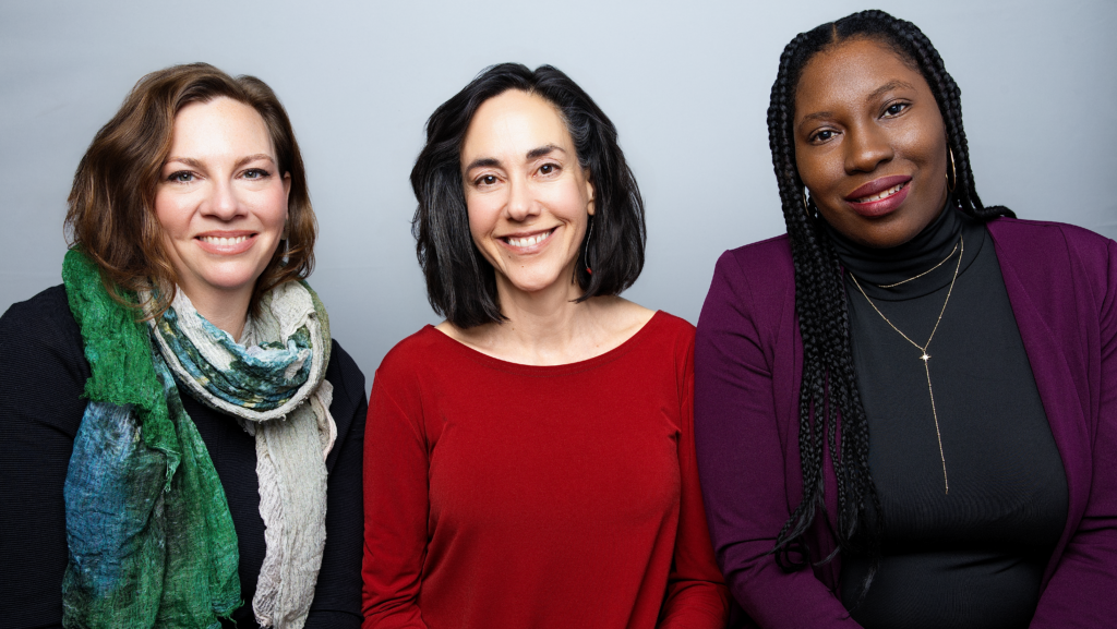 From left to right, Lauren Dasse, Yifat Susskind, and DeLisha Tapscott stand together smiling.